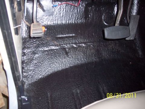 1973 Ford F-250 - Interior view of vehicle floor with pedals and black textured matting.