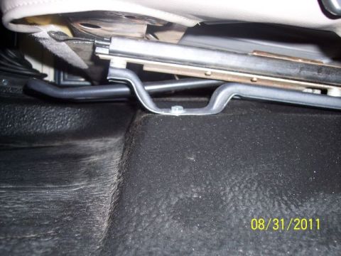 1973 Ford F-250 - Close-up view of the seat mounting bracket and textured floor mat, showing the underside of a vehicle seat.