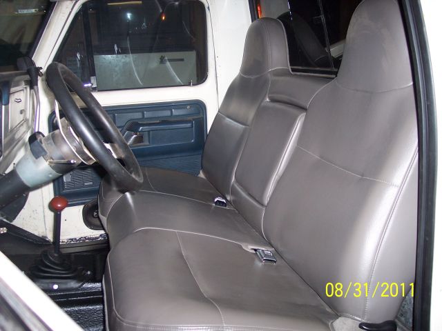 Classic Ford pickup interior with gray 60/40 split bench seat and floor shifter