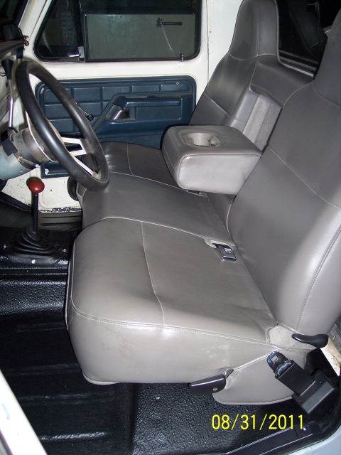 1973 Ford F-250 - The interior of a truck shows a bench seat, armrest, and steering wheel, with a date stamp from 2011.