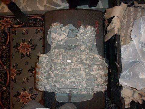 1992 Ford Mustang - A digital camouflage body armor vest is displayed on a patterned rug, with other items in the background.