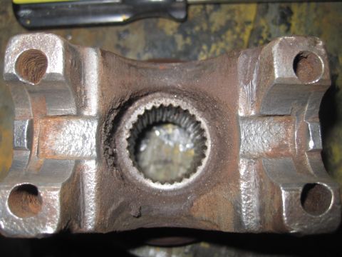 1979 Ford Bronco - Close-up of a rusty driveshaft U-joint yoke, showing wear and corrosion.