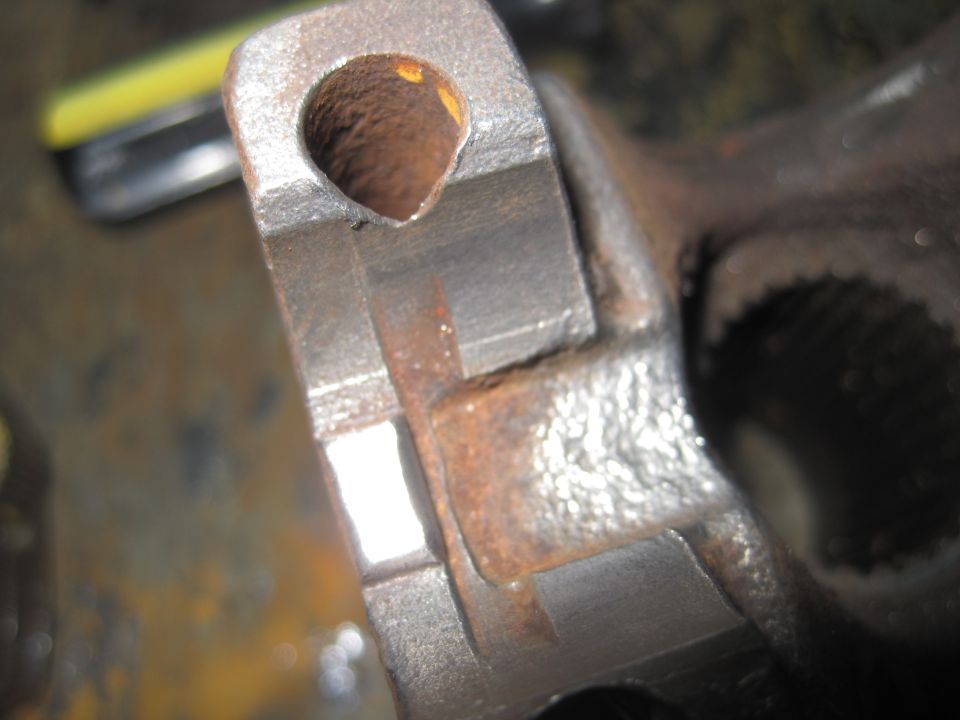 Close-up of a rusted metal component with a circular opening and internal splines