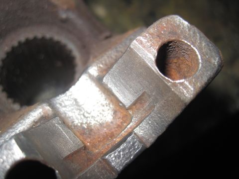1979 Ford Bronco - This is a close-up view of a heavily rusted metal part, possibly from a vehicle's drivetrain.