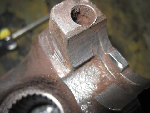 1979 Ford Bronco - Close-up view of a heavily rusted metal component, likely a part from a vehicle's drivetrain or suspension system.
