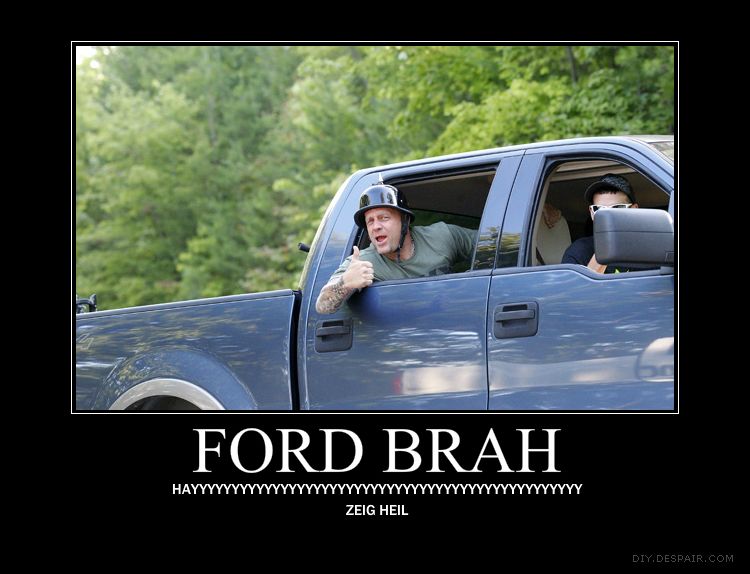 Man in blue pickup truck wearing a helmet gives a thumbs up