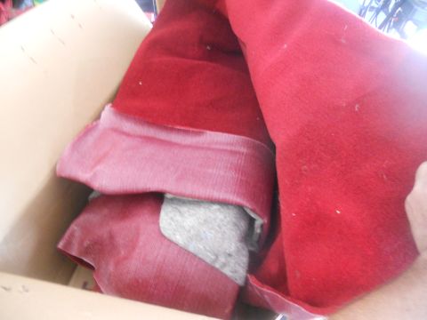 1991 Ford Bronco - A box contains folded red carpet and padding, likely for a vehicle interior.