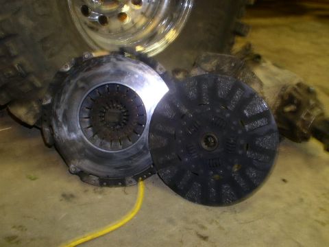 1979 Ford Bronco - Clutch assembly and pressure plate are shown next to a transmission and tire.