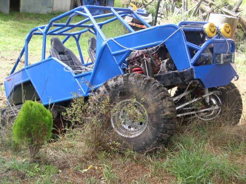 1979 Ford Bronco - This custom-built buggy features a prominent roll cage, large off-road tires, and distinctive smiley face headlights.