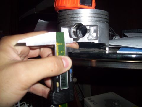 1995 Ford Probe - A piston is being measured with digital calipers, showing a reading of 1.949.