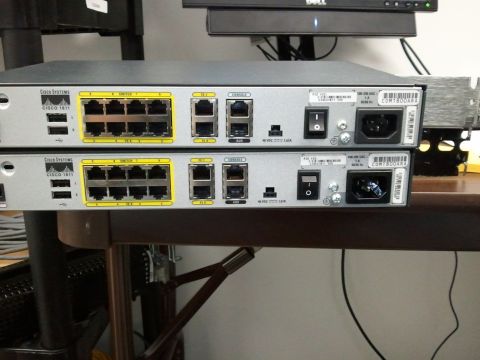 1985 Ford F-150 - Rear view of two Cisco 1811 network switches, each with multiple Ethernet ports and power connectors.