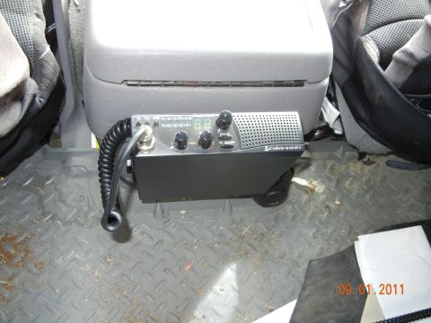 1996 Ford Bronco - A Cobra CB radio is installed in the interior of a vehicle, mounted between the seats.
