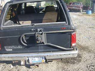 1991 Ford Bronco - This Chevrolet pickup truck is seen from the rear, a spare tire carrier mounted on the tailgate.