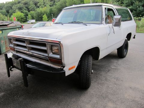 1987 Dodge 1500 - This white SUV has a distinctive grille and bumper, suggesting an older model year.
