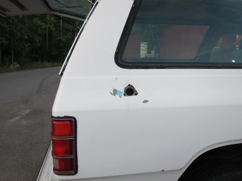 1987 Dodge 1500 - Damage to the rear quarter panel of a 1987 Dodge 1500.