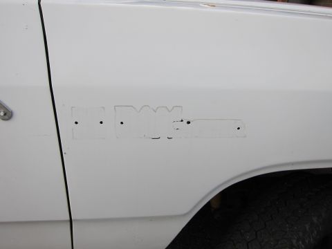 1987 Dodge 1500 - The ghost of a fender emblem remains on this white truck, showing where the lettering was removed.