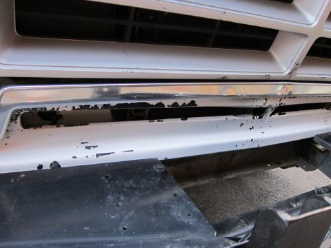 1987 Dodge 1500 - Close-up of the front grille and bumper of a 1987 Dodge 1500, showing wear and tear.