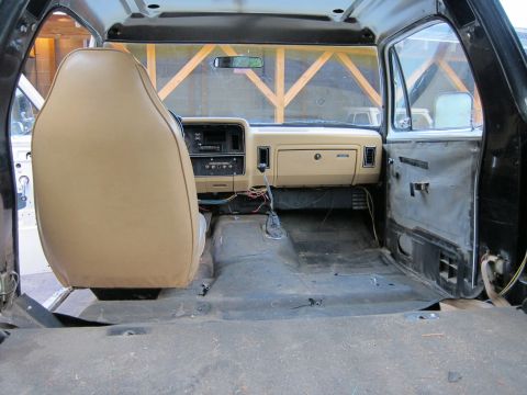 1987 Dodge 1500 - Interior view of a 1987 Dodge 1500 showing the dashboard and driver's seat with the floor stripped.