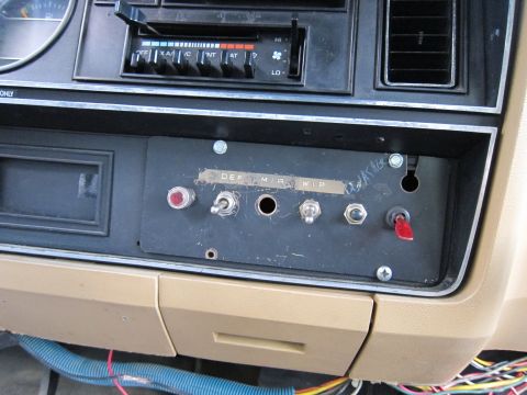1987 Dodge 1500 - Interior view of a dashboard several toggle switches and a red toggle switch, with labels indicating DEF, MIR, and WIP.