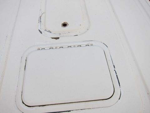 1987 Dodge 1500 - Close-up of a white metal panel showing two access doors, one with hinges.