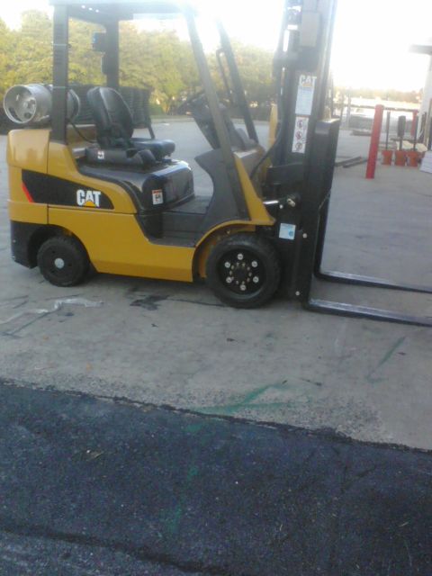1988 Ford Bronco - Forklift with CAT branding and propane tank visible on the side.