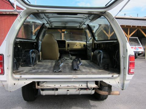 1987 Dodge 1500 - Rear view of a 1987 Dodge 1500 with interior stripped down for work.