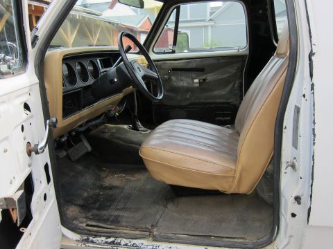 1987 Dodge 1500 - The interior of a 1987 Dodge 1500 pickup truck, tan seats and a tan dashboard with three circular gauges.