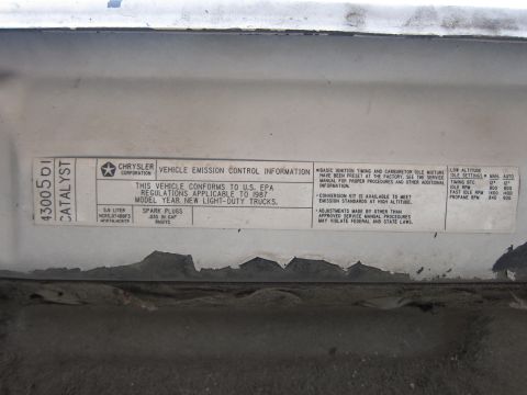 1987 Dodge 1500 - A close-up of a vehicle emission control sticker indicating the model year is 1987.