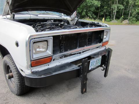 1987 Dodge 1500 - Front view of a 1987 Dodge 1500 pickup truck with its hood open, revealing the engine compartment and a missing grille section.