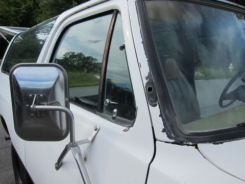 1987 Dodge 1500 - Side view of a 1987 Dodge 1500 showing the door, mirror, and part of the interior.