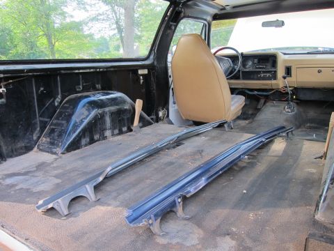 1987 Dodge 1500 - Interior view of a truck undergoing disassembly, showing exposed floor and removed trim.