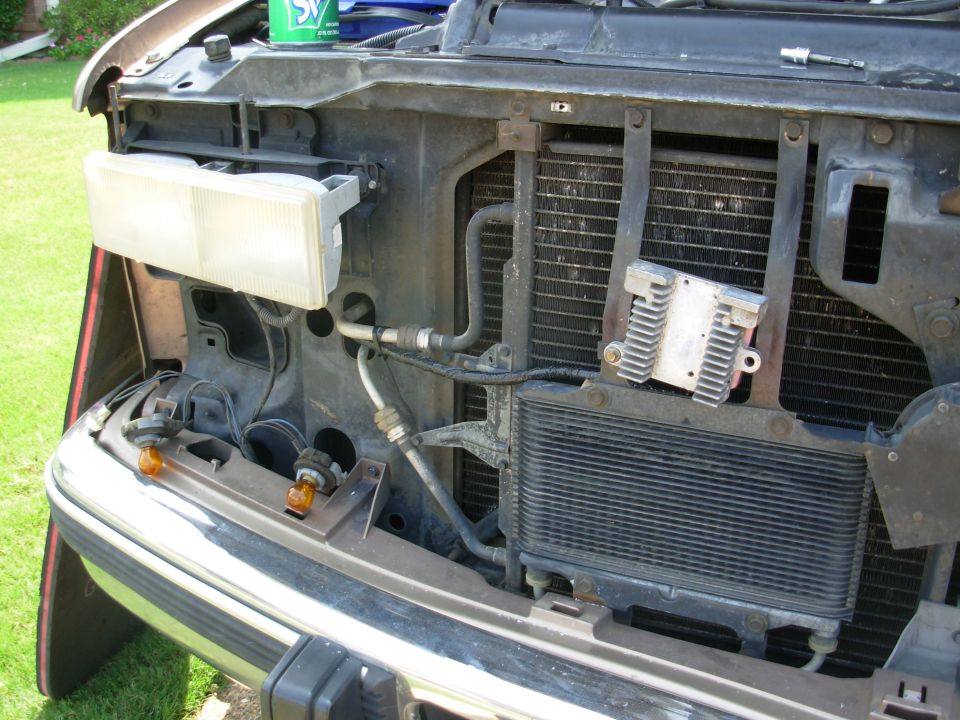 I drilled a hole through one ATF cooler brace & used a U-nut & bolt to attach the heat sink so it will always be in the fan's airflow, even if the truck is idling in Park.  The heat soak off the condenser after shutdown is negligible.