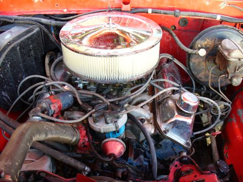 1979 Ford Bronco - Close-up view of a V8 engine bay, highlighting the air intake and ignition system components.