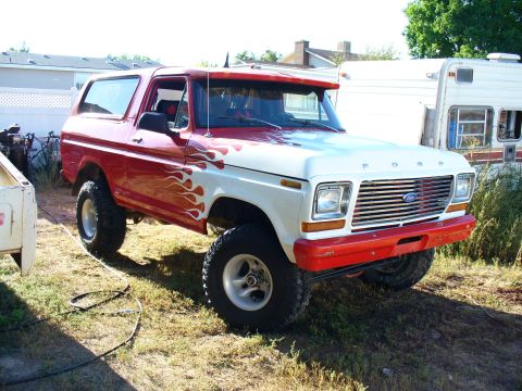 1979 Ford Bronco - This 1979 Ford Bronco features a two-tone red and white paint job with flame decals on the side.