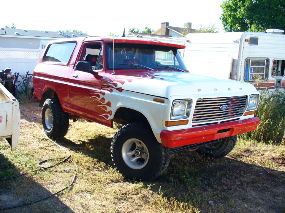 Red and white 1979 Ford Bronco with flame decals, 3/4 front view