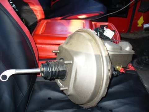 1979 Ford Bronco - A brake booster and master cylinder assembly is placed on the seats of a vehicle.
