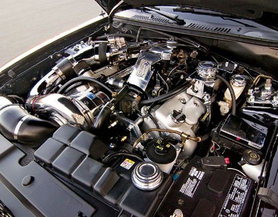 Supercharged V8 engine bay with polished intake and chrome accessories
