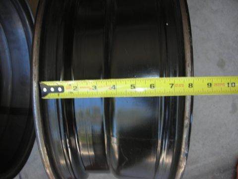 2004 Ford Crown Victoria - Measuring tape on a black wheel rim, likely for an upgrade.