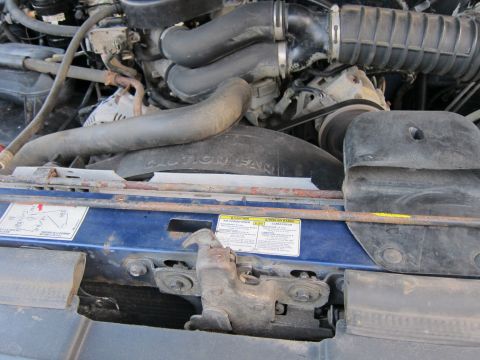 2001 Ford Crown Victoria - Engine bay details with hoses and a fan are visible under the hood.