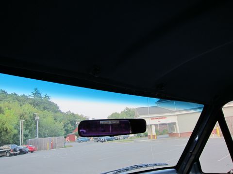 2001 Ford Crown Victoria - View from inside a vehicle shows a parking lot with multiple cars and a pharmacy in the background. Text on the pharmacy sign is visible.
