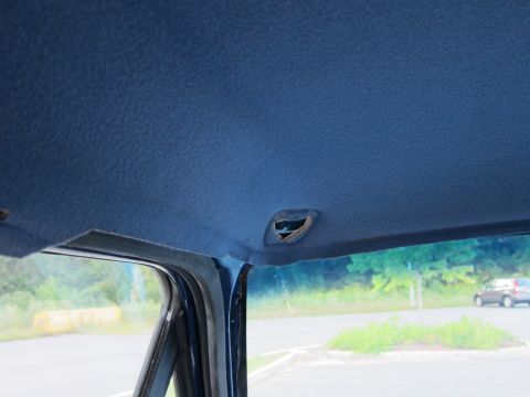 2001 Ford Crown Victoria - Looking out from inside a vehicle, the blue headliner is visible above the windshield.