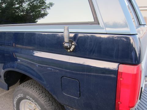 2001 Ford Crown Victoria - Antenna mount attached to the side panel of a dark blue truck.