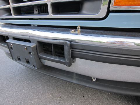 2001 Ford Crown Victoria - Close-up of a truck's front bumper and grille area, showing a license plate bracket.