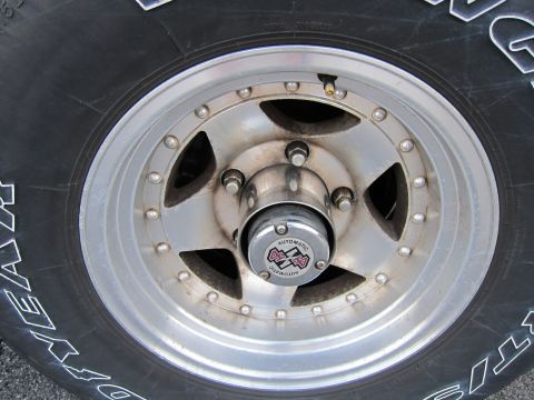 2001 Ford Crown Victoria - A close-up view of a vehicle's wheel and tire, a hubcap with "AUTOMATIC 4x4" text.