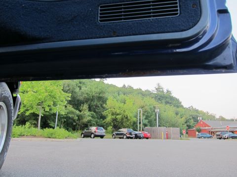 2001 Ford Crown Victoria - A view from inside a vehicle shows a parking lot with multiple cars and trees in the background.