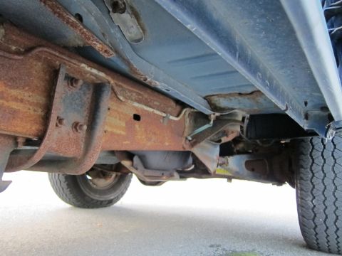 2001 Ford Crown Victoria - The undercarriage of this vehicle displays extensive rust, particularly on the frame and suspension parts.