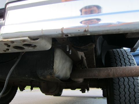 2001 Ford Crown Victoria - A low-angle view of a vehicle's undercarriage, showing the exhaust system and rear tire.
