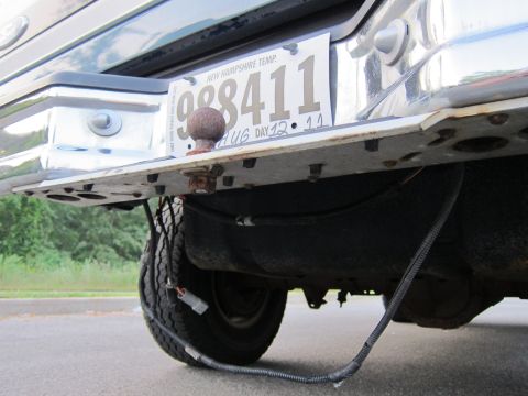 2001 Ford Crown Victoria - The rear bumper assembly, including a trailer hitch and a New Hampshire license plate, is visible in this close-up shot.