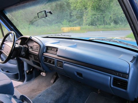 2001 Ford Crown Victoria - Interior view of a blue truck's dashboard, XLT trim and a radio.