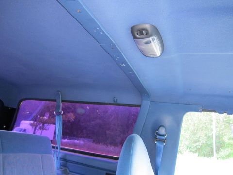 2001 Ford Crown Victoria - Interior view of a blue vehicle, focusing on the headliner, dome light, and seatbelt.